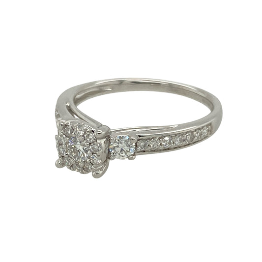 Bring refined sparkle and modern elegance to your collection with this pre-owned 9ct white gold and diamond illusion set solitaire ring—a timeless design with impressive brilliance.

Design: This ring features a brilliant-cut diamond surrounded by a halo of smaller diamonds, creating the illusion of a larger central stone. The look is completed with a half diamond-set band for added shimmer.
