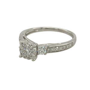 Bring refined sparkle and modern elegance to your collection with this pre-owned 9ct white gold and diamond illusion set solitaire ring—a timeless design with impressive brilliance.

Design: This ring features a brilliant-cut diamond surrounded by a halo of smaller diamonds, creating the illusion of a larger central stone. The look is completed with a half diamond-set band for added shimmer.
