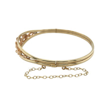 Load image into Gallery viewer, Celebrate heritage and elegance with this pre-owned 9ct yellow and rose gold Clogau Tree of Life bangle—rich in meaning, beautifully detailed, and timeless in design.

Design: The front of the bangle features the iconic Tree of Life motif in a flowing design that symbolises growth, strength, and connection. The front section is 12mm high, offering a bold and graceful presence.

