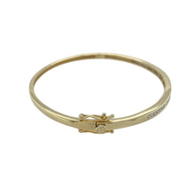 Load image into Gallery viewer, Bring refined sparkle and timeless elegance to your collection with this pre-owned 9ct yellow gold and diamond set bangle—a graceful piece with classic appeal.

Design: This bangle features a sleek 3mm wide front adorned with diamond accents, adding subtle brilliance to its polished surface.
Material: Made from 9-carat yellow gold, the high-shine finish enhances the warm tone and complements the delicate sparkle of the diamonds.

