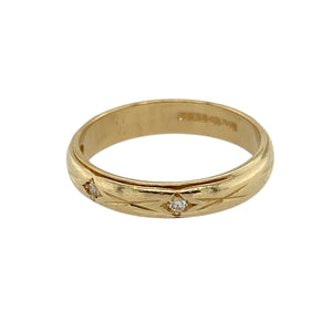 Celebrate love and timeless style with this pre-owned 18ct yellow gold diamond set 'X' kiss patterned band ring—a romantic and elegant design with a touch of sparkle.

Design: The 4mm wide band features a repeating 'X' kiss pattern, with three small diamonds delicately set across the front for subtle brilliance and charm.
Material: Made from 18-carat yellow gold, the polished finish highlights the warmth of the metal and enhances the detailed pattern.
