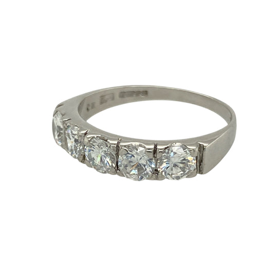 Add clean sparkle and modern elegance to your look with this pre-owned 9ct white gold cubic zirconia set band ring—a timeless design with bold, eye-catching stones.

Design: The band features a row of brilliant 4mm diameter cubic zirconia stones, offering a classic and symmetrical style with standout sparkle.
Material: Made from 9-carat white gold, the polished finish enhances the clarity of the stones and gives the ring a cool, contemporary shine.
