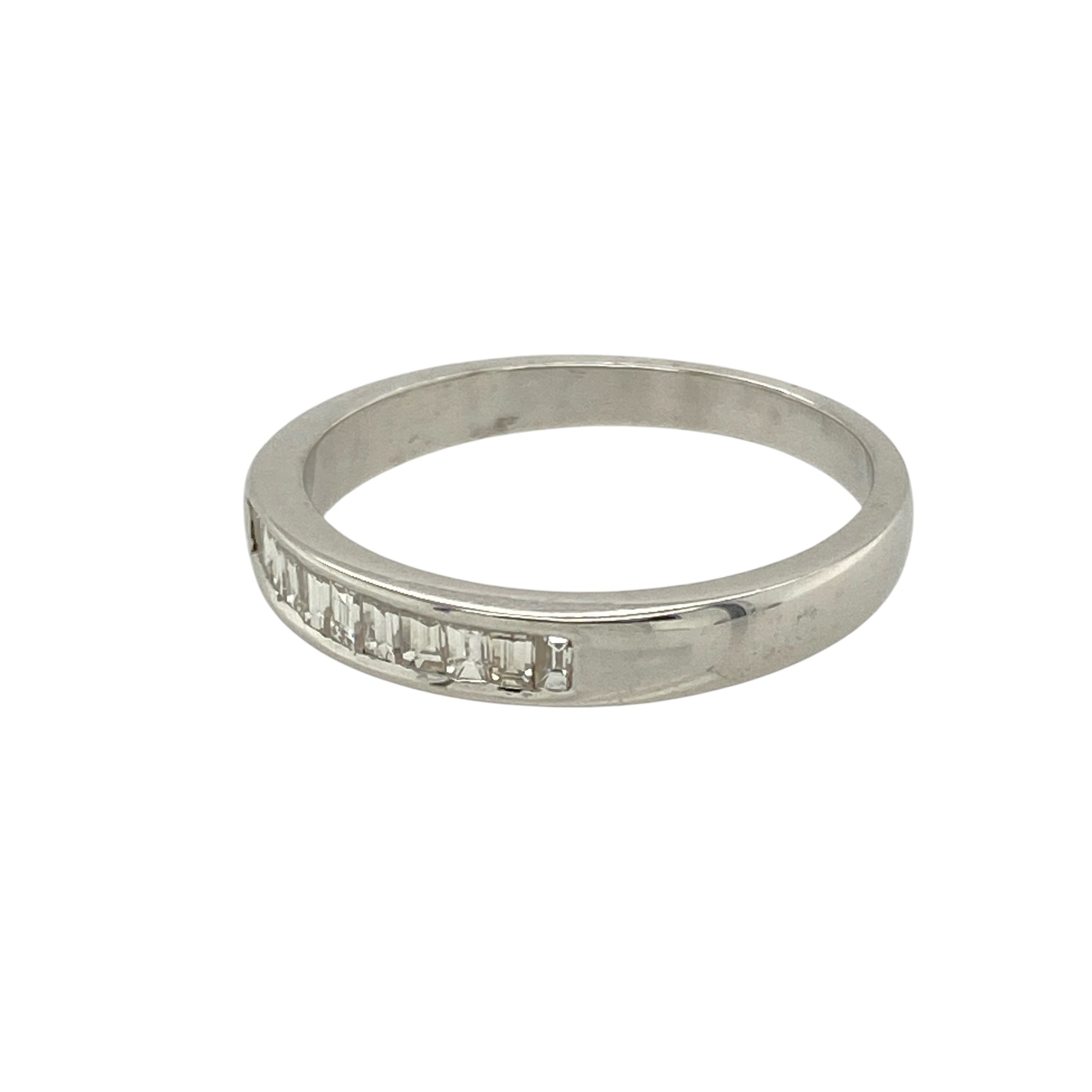 Add refined sparkle and timeless sophistication to your collection with this pre-owned 18ct white gold diamond set band ring—a sleek and elegant design with clean lines and brilliant detail.

Design: The 3mm wide front of the band is set with baguette-cut diamonds, offering a sophisticated and structured look with subtle sparkle.
Material: Made from 18-carat white gold, the polished finish enhances the crisp edges of the baguette stones and delivers a luxurious, contemporary shine.

