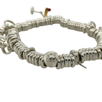 Add playful elegance and personal style to your collection with this pre-owned 925 silver 8" Links of London charm bracelet—a delightful piece that captures joyful spirit and timeless charm, perfect for expressing your personality every day or on special occasions.

Design: This bracelet features a classic Links of London chain adorned with five unique charms: an angel, cocktail glass, heart, elephant, and a frog with a crown, each offering its own symbolic meaning and playful character.
