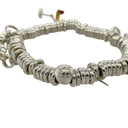 Add playful elegance and personal style to your collection with this pre-owned 925 silver 8" Links of London charm bracelet—a delightful piece that captures joyful spirit and timeless charm, perfect for expressing your personality every day or on special occasions.

Design: This bracelet features a classic Links of London chain adorned with five unique charms: an angel, cocktail glass, heart, elephant, and a frog with a crown, each offering its own symbolic meaning and playful character.
