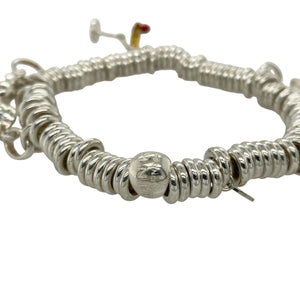 Add playful elegance and personal style to your collection with this pre-owned 925 silver 8" Links of London charm bracelet—a delightful piece that captures joyful spirit and timeless charm, perfect for expressing your personality every day or on special occasions.

Design: This bracelet features a classic Links of London chain adorned with five unique charms: an angel, cocktail glass, heart, elephant, and a frog with a crown, each offering its own symbolic meaning and playful character.
