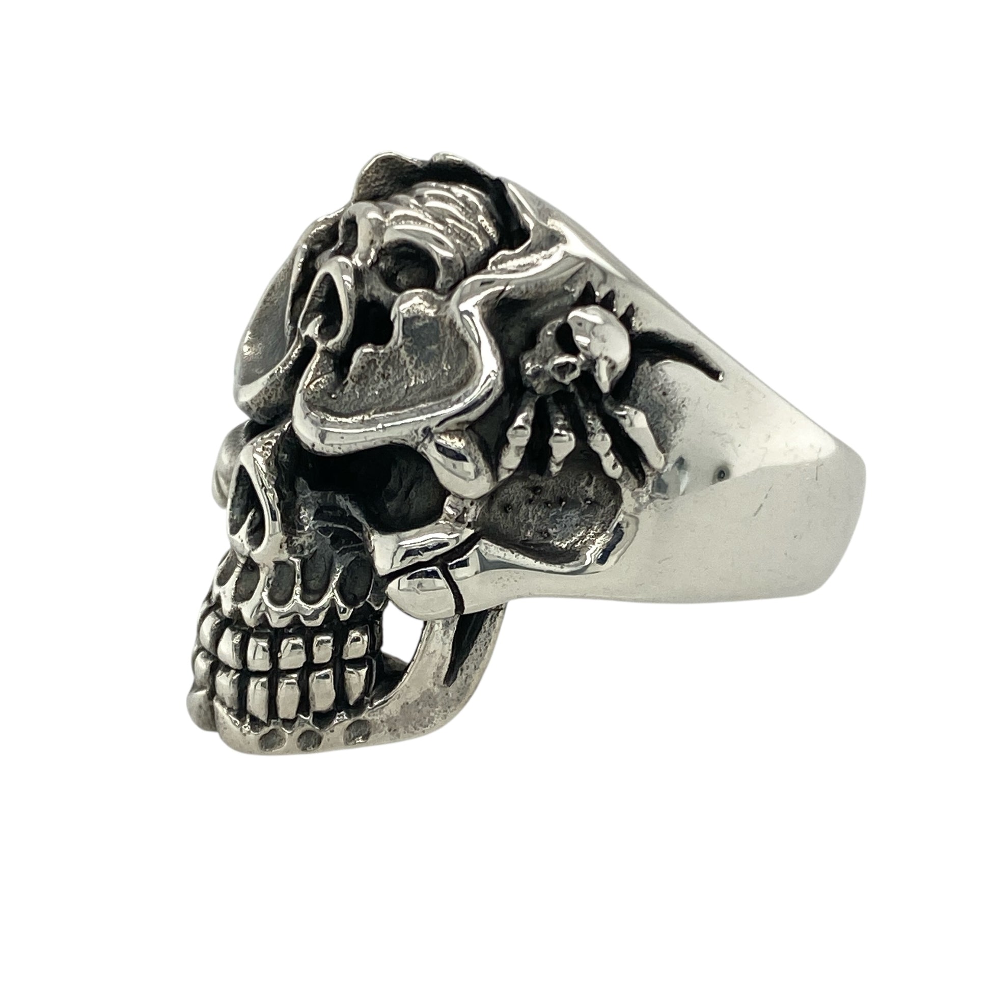 Bring striking detail and fearless style to your collection with this new 925 silver multi skull ring, offering a bold design and powerful presence—perfect for those who love edgy, statement-making jewellery.

Design: The ring features a dramatic front measuring 28mm high, showcasing one central skull with another smaller skull set into its head, and two additional skulls on each side. This layered design creates depth and intensity, symbolising strength, rebellion, and individuality.
