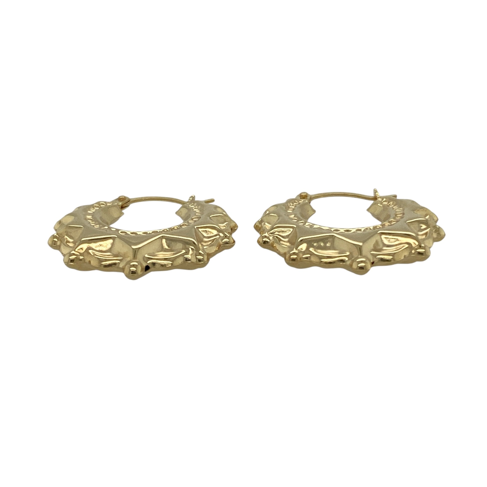 Bring warm elegance and timeless shine to your collection with these new 9ct yellow gold fancy round creole earrings, offering a classic design and refined detail—perfect for adding a touch of sophistication to any look.

Design: The earrings feature a stylish round creole style with a fancy, detailed finish, measuring approximately 20mm in diameter. Their graceful curves and intricate pattern create an effortlessly chic and versatile silhouette.
