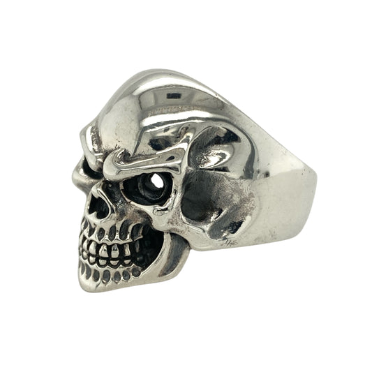 Bring bold edge and fearless style to your collection with this new 925 silver skull ring, offering a striking design and powerful presence—perfect for those who love standout statement pieces.

Design: The ring features a dramatic skull front measuring 25mm high, designed with an open section that adds a raw, edgy character to the piece. The detailed sculpting and hollow element create depth and a rebellious, eye-catching look.
