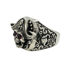 Load image into Gallery viewer, Bring fearless attitude and striking detail to your collection with this new 925 silver and red stone pirate skull ring, offering a bold design and adventurous spirit—perfect for making a powerful statement.

Design: The ring features a detailed pirate skull front measuring 20mm high, accented with two 3mm ruby-coloured stones set in the eyes for an intense, captivating look. The combination of the skull motif and vivid red stones creates a bold, rebellious focal point.

