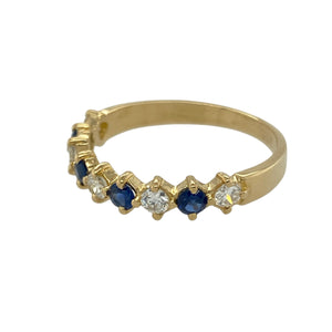 Bring luxurious elegance and timeless colour to your collection with this pre-owned 18ct yellow gold diamond and sapphire set band ring, offering a refined design and sophisticated sparkle—perfect for adding a classic statement to any look.

Design: The ring features a beautifully balanced band design adorned with alternating diamonds and sapphires, each sapphire measuring approximately 3mm in diameter. 