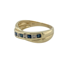 Load image into Gallery viewer, Bring graceful elegance and timeless colour to your collection with this pre-owned 9ct yellow gold diamond and sapphire set crossover band ring, offering a refined design and sophisticated sparkle—perfect for adding a touch of classic charm to any look.

Design: The ring features an elegant crossover band design adorned with alternating diamonds and sapphires, each sapphire measuring approximately 2mm in diameter. The deep blue sapphires beautifully contrast with the shimmering diamonds
