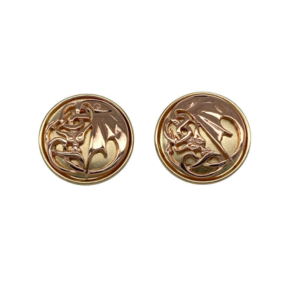 Bring bold heritage and striking detail to your collection with these pre-owned 9ct yellow and rose gold Clogau Welsh dragon wing round stud earrings, offering a unique design and powerful presence—perfect for making a statement with a touch of symbolism.

Design: The earrings feature a distinctive round stud design adorned with the iconic Welsh dragon wing motif, beautifully crafted in contrasting yellow and rose gold. 