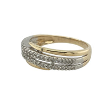 Load image into Gallery viewer, Bring modern elegance and radiant sparkle to your collection with this pre-owned 9ct yellow and white gold and diamond set crossover band ring, offering a striking design and sophisticated presence—perfect for adding a bold yet refined statement to any look.

Design: The ring features an eye-catching crossover design at the front, measuring 8mm wide, adorned with two rows of shimmering diamonds. The flowing lines create a dynamic and contemporary silhouette
