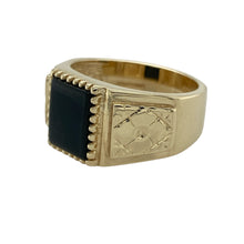 Load image into Gallery viewer, Bring bold sophistication and striking detail to your collection with this pre-owned 9ct yellow gold onyx signet ring, offering a refined blend of strong design and timeless style—ideal for those who appreciate distinctive statement pieces.

Design: The ring features a rectangular 10mm by 8mm onyx centre, framed in a sleek gold setting that highlights the deep, polished black of the stone. The shoulders are adorned with an elegant flower-style pattern, adding a subtle decorative touch and extra character.
