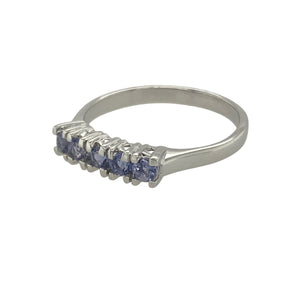 Bring vibrant colour and modern elegance to your collection with this pre-owned 9ct white gold and tanzanite set band ring, offering a refined blend of delicate sparkle and contemporary charm—perfect for adding a touch of sophistication to any look.

Design: The ring features a series of tanzanite stones, each measuring 2mm in diameter, set across the band to create a continuous line of soft violet-blue brilliance.
