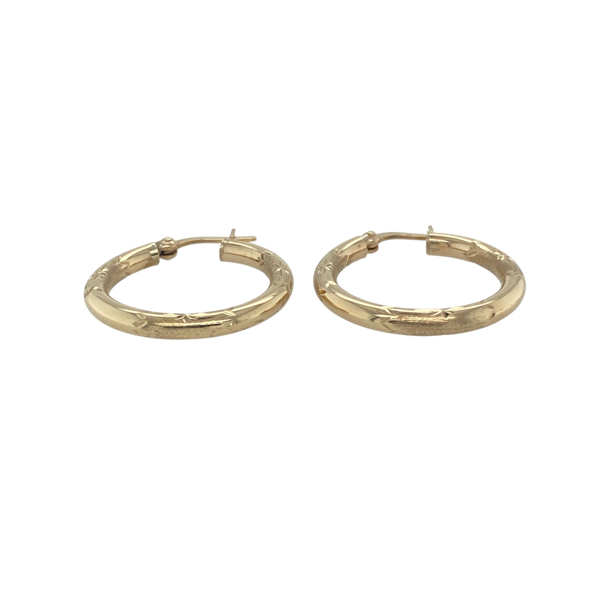 Bring timeless texture and elegant shine to your collection with these pre-owned 9ct yellow gold patterned hoop creole earrings, offering a refined blend of classic style and eye-catching detail—perfect for any occasion.

Design: Each earring features a polished hoop creole shape adorned with an intricate pattern, adding depth and visual interest while maintaining a classic silhouette.
