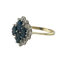Load image into Gallery viewer, Bring rich colour and timeless sparkle to your collection with this pre-owned 9ct yellow gold diamond and sapphire set cluster ring, offering a striking blend of classic elegance and eye-catching detail—perfect for special occasions or everyday luxury.

Design: The ring features a bold cluster made up of four oval sapphire stones (two measuring 6mm by 4mm and two measuring 5mm by 3mm), beautifully surrounded by small brilliant cut diamonds for a radiant and sophisticated look.

