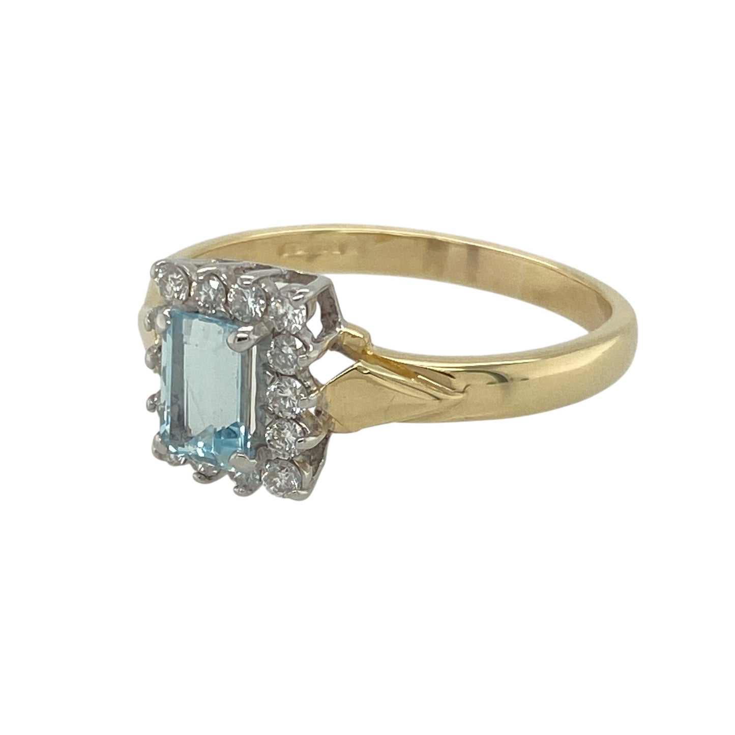 Bring serene colour and timeless sparkle to your collection with this pre-owned 18ct yellow gold diamond and aquamarine set cluster ring, offering a beautiful blend of elegant detail and sophisticated charm—perfect for special occasions or everyday luxury.

Design: The ring features a rectangular aquamarine stone measuring 6mm by 4mm at the centre, surrounded by a sparkling cluster of diamonds that enhances its soft blue hue and adds radiant brilliance.
