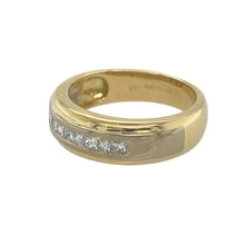 Load image into Gallery viewer, Bring refined sparkle and modern elegance to your collection with this pre-owned 18ct yellow and white gold diamond set band ring, offering a beautiful blend of sophisticated design and timeless detail—perfect for marking life’s special moments.

Design: The ring features a 5mm wide band with a sleek white gold centre channel set with princess cut diamonds, totalling approximately 0.20ct, creating a clean and contemporary focal point.

