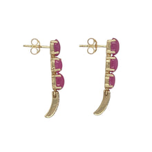 Load image into Gallery viewer, Bring rich colour and refined sparkle to your collection with these pre-owned 9ct yellow gold diamond and ruby set drop earrings, offering a stunning blend of classic elegance and vibrant detail—perfect for making a graceful statement.

Design: Each earring features an oval ruby stone measuring 6mm by 4mm, beautifully accented with sparkling diamonds above, creating a luxurious and eye-catching drop design.

