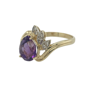 Bring rich colour and graceful sparkle to your collection with this pre-owned 9ct yellow gold diamond and amethyst set twist ring, offering an elegant silhouette and eye-catching design — perfect for statement wear or refined everyday luxury.

Design: The ring features a 9mm by 7mm teardrop-shaped amethyst as its centrepiece, accented by a fan-style arrangement of sparkling diamonds that follow the curve of the twisted setting.
Material: Made from 9-carat yellow gold