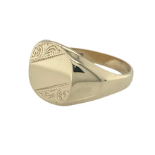 Load image into Gallery viewer, Bring bold elegance and classic detailing to your collection with this pre-owned 9ct yellow gold patterned signet ring—a substantial piece with timeless character and presence.

Design: The ring features a large 14mm high front with an engraved pattern, offering a distinguished and traditional look with refined detail.
Material: Made from 9-carat yellow gold, the polished finish enhances the rich tone and depth of the engraved design, giving the piece a confident, stately appearance.

