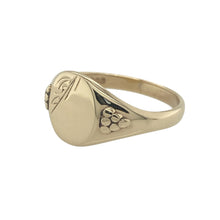Load image into Gallery viewer, Bring refined detail and vintage character to your collection with this pre-owned 9ct yellow gold patterned oval signet ring—a classic piece with timeless style and personal charm.

Design: The ring features a 12mm high oval-shaped front with intricate engraved detailing, offering a traditional look with added decorative appeal.
Material: Made from 9-carat yellow gold, the polished finish enhances the engraved pattern and brings out the warmth and richness of the metal.

