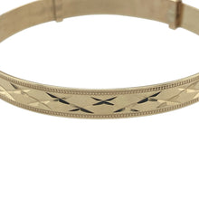 Load image into Gallery viewer, Bring cherished detail and lasting sentiment to your collection with this pre-owned 9ct yellow gold kiss diamond cut patterned expanding baby bangle—a timeless keepsake designed to grow with your little one.

Design: The bangle features a classic expanding style with a 5mm wide band, decorated with a delicate kiss-inspired diamond cut pattern for added sparkle and charm.
Material: Made from 9-carat yellow gold, the polished finish enhances the faceted details and offers a warm, elegant glow.

