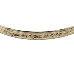 Bring timeless style and detailed elegance to your collection with this pre-owned 9ct yellow solid gold patterned bangle—a classic design with rich texture and lasting appeal.

Design: The bangle features a 5mm wide band adorned with intricate engraved patterns, creating a beautifully textured finish with vintage-inspired charm.
Material: Made from solid 9-carat yellow gold, the polished surface highlights the decorative detail and adds a warm, radiant glow.
