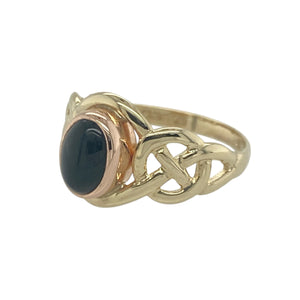 Bring heritage style and bold contrast to your collection with this pre-owned 9ct yellow and rose gold onyx set Clogau Celtic knot ring—a meaningful design rich in symbolism and timeless elegance.

Design: The ring features a 7mm by 5mm deep black onyx stone framed by an intricate Celtic knot design, blending warm yellow and rose gold tones in true Clogau style.
Material: Made from 9-carat yellow and rose gold, the polished finish enhances both the dark sheen of the onyx and the detailed knotwork.
