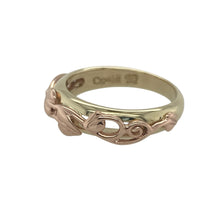 Load image into Gallery viewer, Bring symbolic beauty and elegant heritage to your collection with this pre-owned 9ct yellow gold Clogau Tree of Life band ring—a meaningful design inspired by growth, strength, and connection.

Design: The ring features an intricately detailed Tree of Life pattern across the 5mm wide front, blending flowing lines and natural motifs in a graceful, continuous design.
Material: Made from 9-carat yellow gold, the polished finish enhances the raised pattern and adds a warm, glowing richness to the band.

