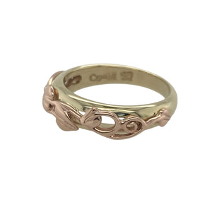 Bring symbolic beauty and elegant heritage to your collection with this pre-owned 9ct yellow gold Clogau Tree of Life band ring—a meaningful design inspired by growth, strength, and connection.

Design: The ring features an intricately detailed Tree of Life pattern across the 5mm wide front, blending flowing lines and natural motifs in a graceful, continuous design.
Material: Made from 9-carat yellow gold, the polished finish enhances the raised pattern and adds a warm, glowing richness to the band.
