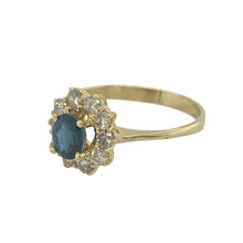 Load image into Gallery viewer, Bring classic elegance and timeless sparkle to your collection with this pre-owned 18ct yellow gold diamond and sapphire set cluster ring—a refined design that combines rich colour with vintage-inspired brilliance.

Design: The ring features a 5mm by 4mm oval sapphire at the centre, surrounded by a sparkling halo of brilliant-cut diamonds in a traditional cluster setting for a beautifully balanced look.

