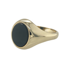 Load image into Gallery viewer, Bring bold contrast and classic form to your jewellery collection with this pre-owned 9ct yellow gold and onyx oval signet ring—designed for timeless impact and refined strength.

Design: An 11mm by 9mm oval-shaped onyx sits at the centre of a traditional signet setting, offering a bold, smooth surface and elegant profile.
Material: Made from 9-carat yellow gold, the polished finish highlights the deep black of the onyx, creating a rich and eye-catching contrast.

