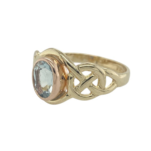 Celebrate heritage and colour with this pre-owned 9ct yellow and rose gold Clogau ring, featuring a vibrant blue topaz and elegant Celtic detailing.

Design: A 7mm by 5mm oval-cut blue topaz sits at the centre of an intricately shaped Celtic design, blending symbolic curves with vivid sparkle.
Material: Made from 9-carat yellow gold with rose gold accents, the ring carries the distinctive Clogau Welsh gold touch, known for its warmth and rarity.
