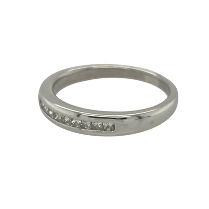 Add sleek sophistication and contemporary sparkle with this pre-owned 9ct white gold band ring, featuring elegant princess cut diamonds in a clean, modern setting.

Design: The front of the band measures 3.5mm wide and is channel set with square princess cut diamonds, creating a smooth and structured line of brilliance.
Material: Made from 9-carat white gold, the cool-toned finish offers a polished backdrop that enhances the clarity and geometric beauty of the diamonds.

