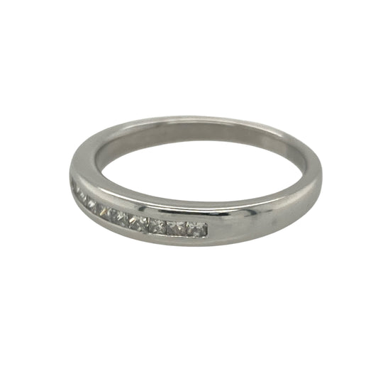 Add sleek sophistication and contemporary sparkle with this pre-owned 9ct white gold band ring, featuring elegant princess cut diamonds in a clean, modern setting.

Design: The front of the band measures 3.5mm wide and is channel set with square princess cut diamonds, creating a smooth and structured line of brilliance.
Material: Made from 9-carat white gold, the cool-toned finish offers a polished backdrop that enhances the clarity and geometric beauty of the diamonds.

