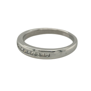 Add sleek sophistication and contemporary sparkle with this pre-owned 9ct white gold band ring, featuring elegant princess cut diamonds in a clean, modern setting.

Design: The front of the band measures 3.5mm wide and is channel set with square princess cut diamonds, creating a smooth and structured line of brilliance.
Material: Made from 9-carat white gold, the cool-toned finish offers a polished backdrop that enhances the clarity and geometric beauty of the diamonds.

