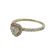 Load image into Gallery viewer, Add romantic sparkle and timeless shine to your collection with this pre-owned 9ct yellow gold halo heart ring, set with glittering cubic zirconia stones.

Design: The ring features a 5mm heart-shaped cubic zirconia at the centre, surrounded by a halo of smaller stones with additional stones set along the shoulders for extra brilliance.
Material: Made from 9-carat yellow gold, the polished finish enhances the sparkle of the stones and adds a warm, classic touch.

