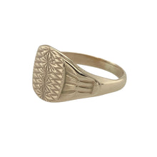 Load image into Gallery viewer, Add classic style and intricate detail to your collection with this pre-owned 9ct yellow gold patterned signet ring—elegant, traditional, and perfect for everyday wear.

Design: The front of the ring measures 10mm high and features a smooth oval face framed by finely detailed patterned shoulders for added texture and interest.
Material: Made from 9-carat yellow gold, the polished finish provides a warm glow and enhances the vintage-inspired design.

