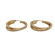Load image into Gallery viewer, Make a bold statement with these pre-owned 9ct yellow gold double hoop twist creole earrings—stylish, eye-catching, and full of movement.

Design: These earrings feature an elegant double hoop design with a twisted creole shape, creating layered curves that catch the light from every angle.
Material: Made from 9-carat yellow gold, the high-polish finish enhances the sculptural form and adds a luxurious golden glow.


