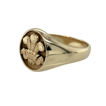 Load image into Gallery viewer, Celebrate tradition and pride with this pre-owned 9ct yellow gold Welsh Three Feathers signet ring—bold, meaningful, and rich in heritage.

Design: The front of the ring measures 12mm high and features an engraved Welsh Three Feathers emblem on an oval face, representing honour, unity, and national pride.
Material: Made from 9-carat yellow gold, the polished finish enhances the detailed engraving and adds a warm, classic glow.

