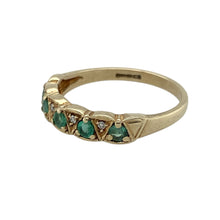 Load image into Gallery viewer, Add subtle sparkle and classic colour to your collection with this pre-owned 9ct yellow gold diamond and emerald set band ring—refined, elegant, and perfect for everyday wear.

Design: The front of the band is 4mm wide and features a series of alternating diamonds and emeralds, offering a delicate balance of shimmer and vibrant green.
Material: Made from 9-carat yellow gold, the polished finish highlights the contrast between the sparkling diamonds and rich emeralds.

