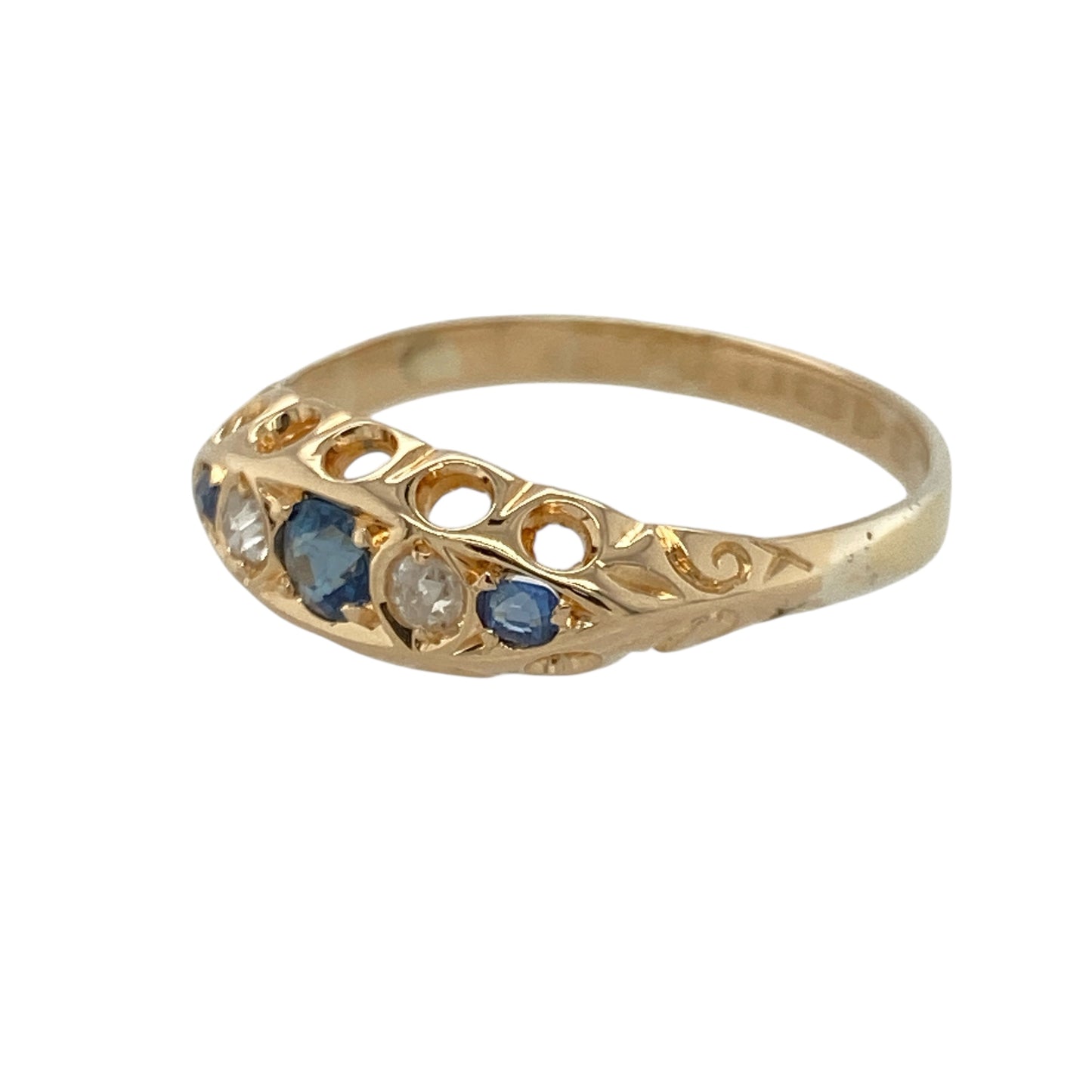 Add vintage elegance and rich colour to your collection with this pre-owned 18ct yellow gold diamond and sapphire ring—classic, refined, and beautifully detailed.

Design: The front of the 6mm wide band features a trio of deep blue sapphires, each separated by a sparkling diamond, creating a balanced and timeless layout.
Material: Made from 18-carat yellow gold, the high-polish finish enhances the vivid tones of the sapphires and the brilliance of the diamonds.
