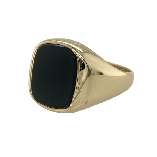 Classic and confident, this pre-owned 9ct yellow gold onyx signet ring offers timeless appeal with bold contrast—perfect for statement wear or a signature everyday piece.

Design: The ring features an approximately 11mm by 9mm oval onyx stone, set in a smooth bezel that highlights the rich depth of the stone.
Material: Made from 9-carat yellow gold, the polished finish complements the dark onyx with a warm, refined glow.
