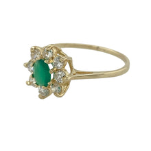 Load image into Gallery viewer, Delicate and full of charm, this pre-owned 9ct yellow gold flower cluster ring features vibrant colour and soft sparkle—perfect for adding a touch of elegance to any occasion.

Design: The ring showcases a 6mm by 5mm oval emerald-coloured green stone at the centre, surrounded by a cluster of cubic zirconia stones arranged in a floral design.
Material: Made from 9-carat yellow gold, the polished finish enhances the rich green centre and bright sparkle of the surrounding stones.

