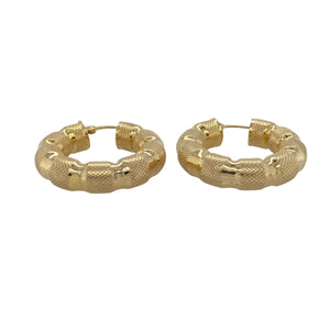 Bold and full of texture, these pre-owned 9ct yellow gold bubble-style creole earrings make a standout statement—perfect for elevating both casual and occasion looks.

Design: Each earring features a hoop creole shape with a textured bubble-style finish, creating depth, shine, and a playful yet sophisticated look.
Material: Made from 9-carat yellow gold, the polished and textured surfaces enhance the warm tone with eye-catching dimension.
