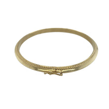 Load image into Gallery viewer, Delicate and detailed, this pre-owned 9ct yellow gold hinged bangle features classic styling with elegant texture—perfect for everyday wear or special occasions.

Design: The bangle features an oval shape with a 4mm wide band, finished with a refined beaded edge that adds subtle texture and vintage-inspired charm.
Material: Made from 9-carat yellow gold, the polished surface enhances the beaded detailing with a warm, elegant glow.

