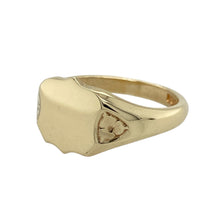 Load image into Gallery viewer, Classic with a touch of charm, this pre-owned 9ct yellow gold shield signet ring features clean lines and subtle detailing—perfect for everyday wear or a meaningful gift.

Design: The ring showcases a 10mm high plain shield-shaped front, ideal for engraving, with delicate flower-style patterns on the shoulders adding a hint of vintage elegance.
Material: Made from 9-carat yellow gold, the polished finish enhances the smooth surface and fine shoulder detailing.

